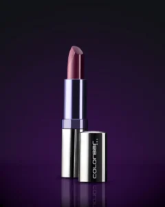 Colorbar lipstick in mauve shade with metallic purple and silver packaging against a dark purple background.