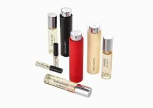 "Assorted Two Saints perfume bottles and spray canisters arranged on a white background, featuring names like chic la nuit and kokogoose for luxury fragrance product photography".